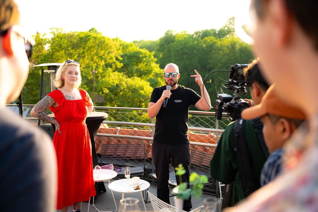 Christoph (with mic) talking at a community event in Estonia